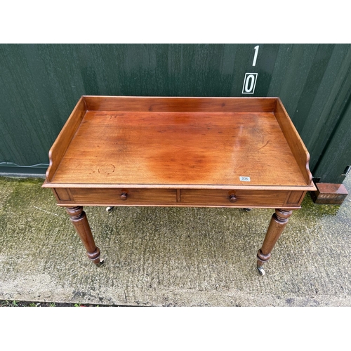 236 - A Victorian mahogany two drawer writing table with gallery top 107x68x90