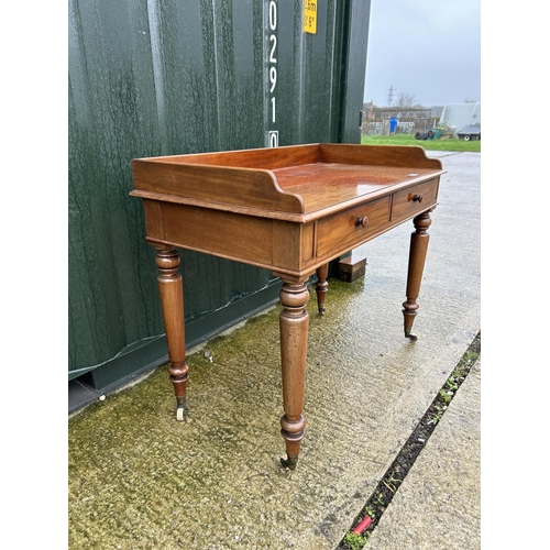 236 - A Victorian mahogany two drawer writing table with gallery top 107x68x90