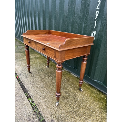 236 - A Victorian mahogany two drawer writing table with gallery top 107x68x90