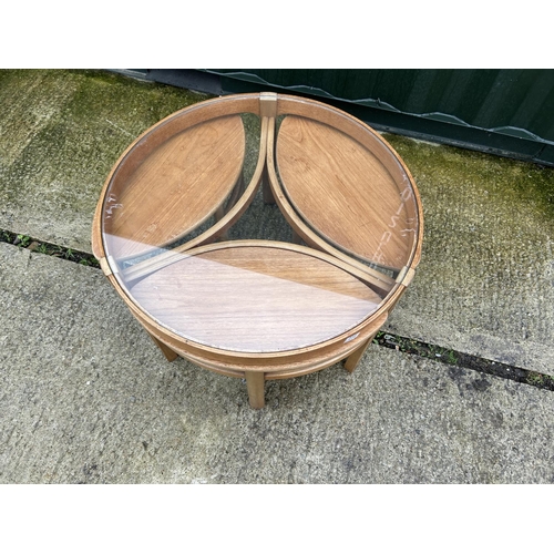 238 - A Nathan teak circular glass top nest of four tables