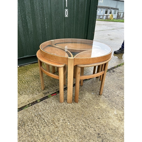 238 - A Nathan teak circular glass top nest of four tables