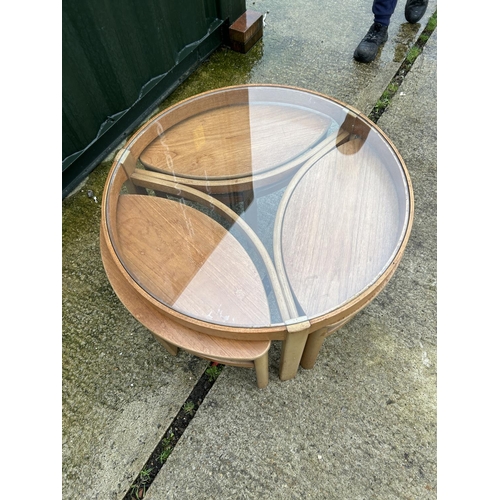 238 - A Nathan teak circular glass top nest of four tables