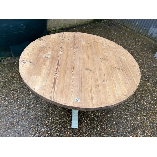 265 - A country pine circular kitchen table with green painted base 120cm diameter