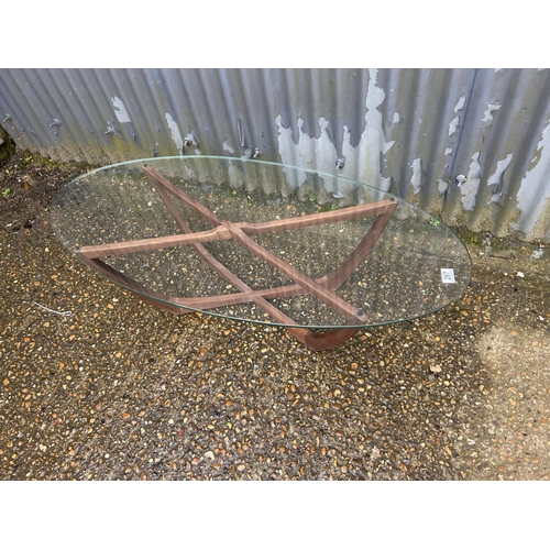 267 - A teak coffee table with oval glass top