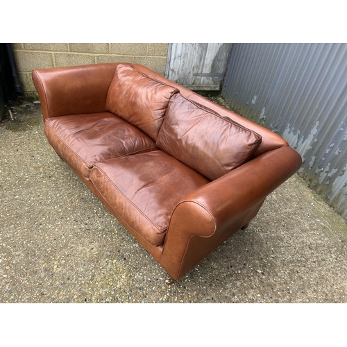 28 - A good quality tan brown leather two seater sofa by LAURA ASHLEY 185cm wide