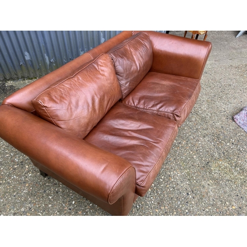 28 - A good quality tan brown leather two seater sofa by LAURA ASHLEY 185cm wide