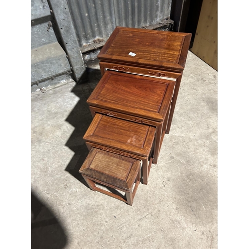 3 - A nest of four oriental style occasional tables