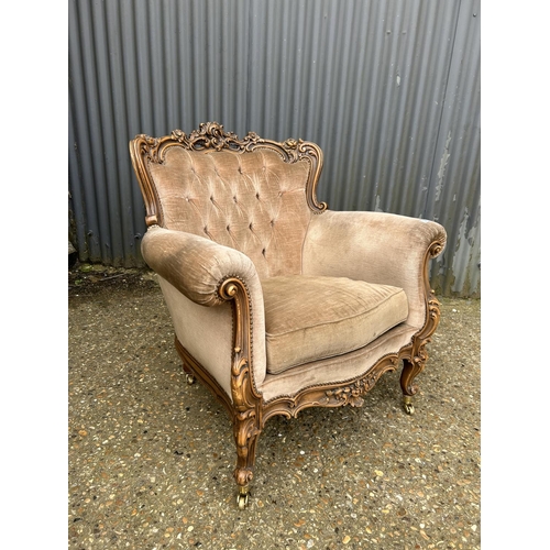 30 - An ornate ROCCO style armchair with golden brown upholstery