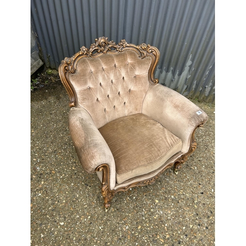 30 - An ornate ROCCO style armchair with golden brown upholstery