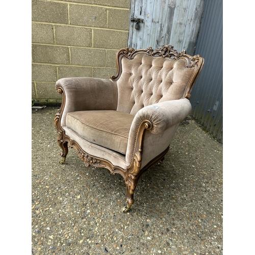 30 - An ornate ROCCO style armchair with golden brown upholstery