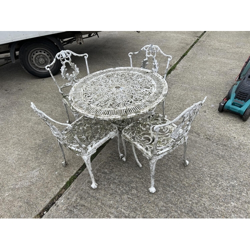 306 - A circular white aluminium garden table and four chairs