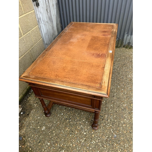 37 - A  large continental mahogany writing desk, five drawers and two sliding extensions with a golden le... 