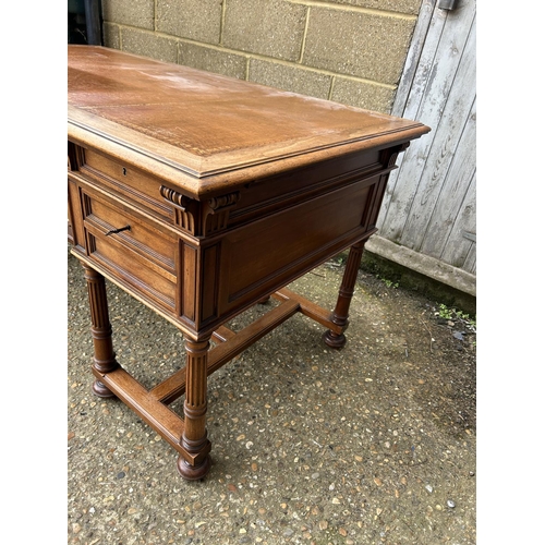 37 - A  large continental mahogany writing desk, five drawers and two sliding extensions with a golden le... 