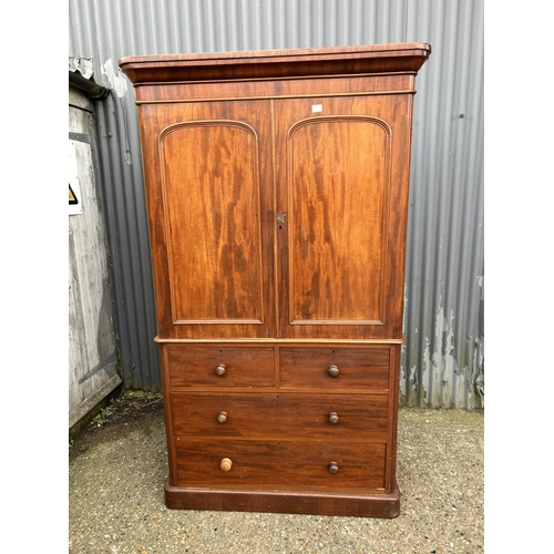 42 - A Victorian mahogany linen press with slides to the top over a four drawer base 100x47x207