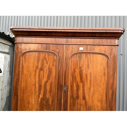 42 - A Victorian mahogany linen press with slides to the top over a four drawer base 100x47x207