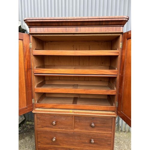 42 - A Victorian mahogany linen press with slides to the top over a four drawer base 100x47x207