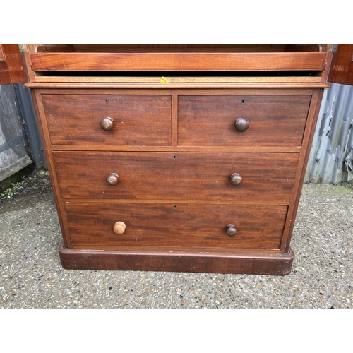 42 - A Victorian mahogany linen press with slides to the top over a four drawer base 100x47x207