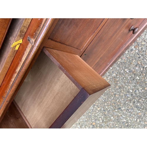 42 - A Victorian mahogany linen press with slides to the top over a four drawer base 100x47x207