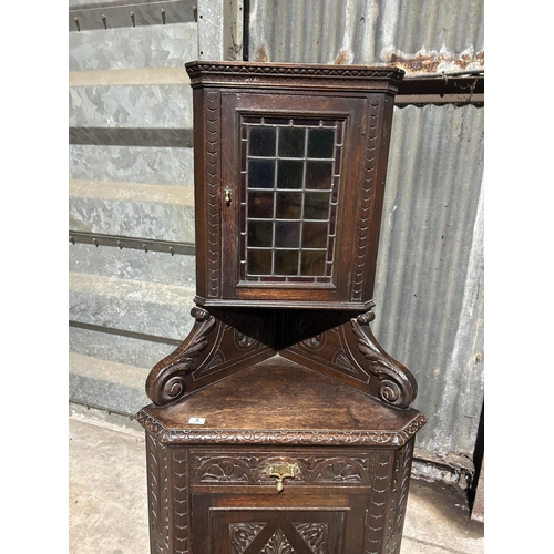 5 - An unusual carved oak corner cupboard with leaded glass top