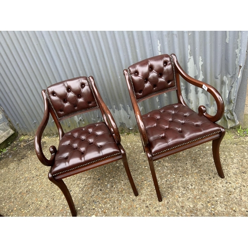 50 - A pair of brown leather chesterfield chairs