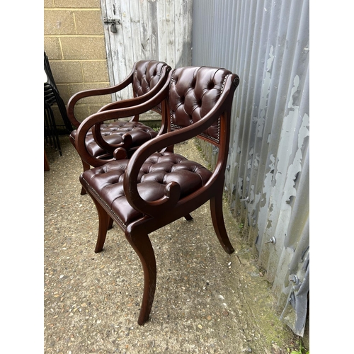 50 - A pair of brown leather chesterfield chairs