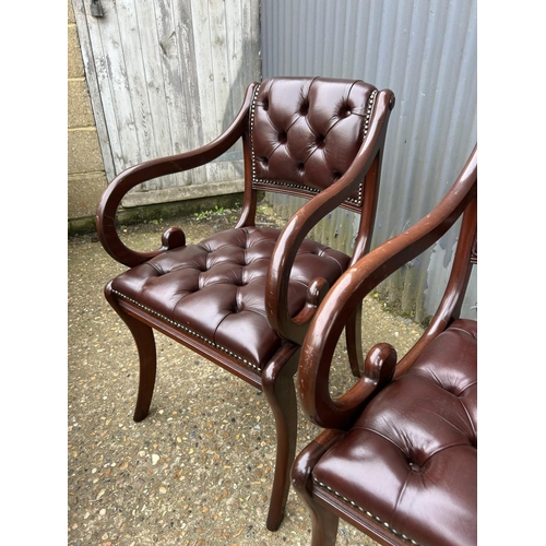 50 - A pair of brown leather chesterfield chairs