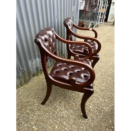 50 - A pair of brown leather chesterfield chairs