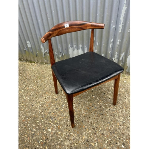 51 - A rosewood cow horn chair with black vinyl seat