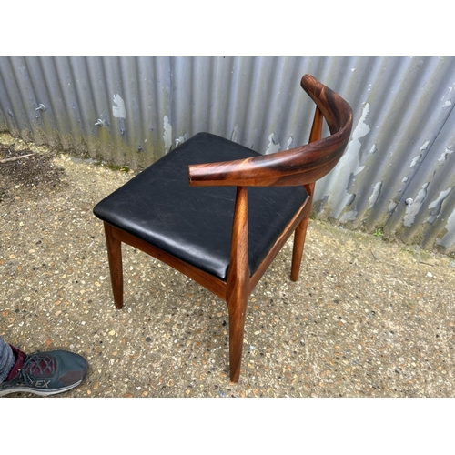 51 - A rosewood cow horn chair with black vinyl seat