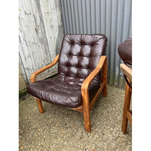 52 - Three teak framed lounger chairs with brown leather seats