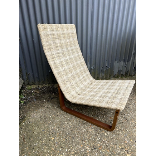 55 - A pair of mid century teak framed lounger chairs with oatmeal upholstery