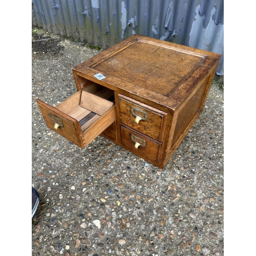 69 - A small oak four drawer filing box