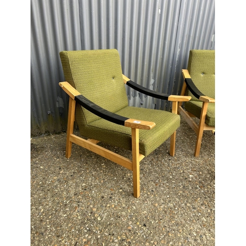 70 - A pair of danish style chairs upholstered in green together with matching stool