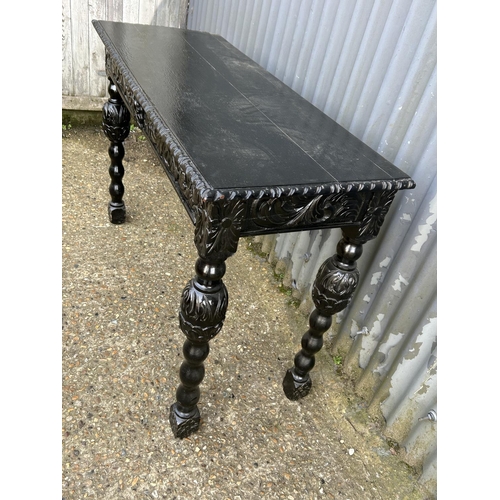 74 - A black varnished oak two drawer hall table 120x46x80