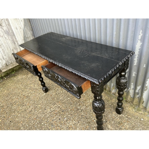 74 - A black varnished oak two drawer hall table 120x46x80