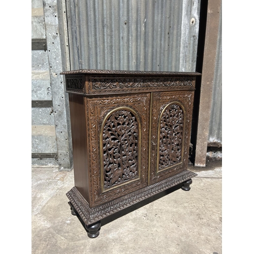 8 - A carved hardwood two door cupboard with drawer  87x30x88