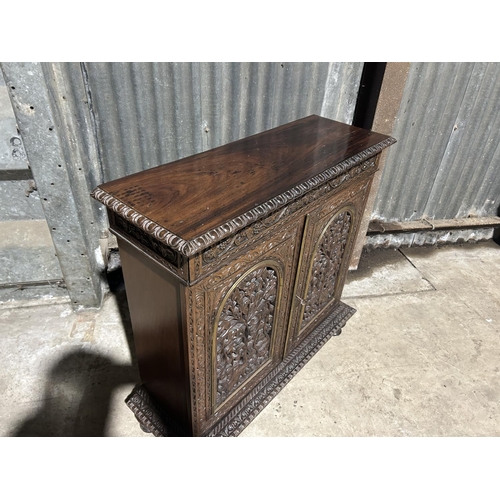 8 - A carved hardwood two door cupboard with drawer  87x30x88