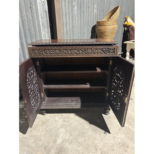 8 - A carved hardwood two door cupboard with drawer  87x30x88