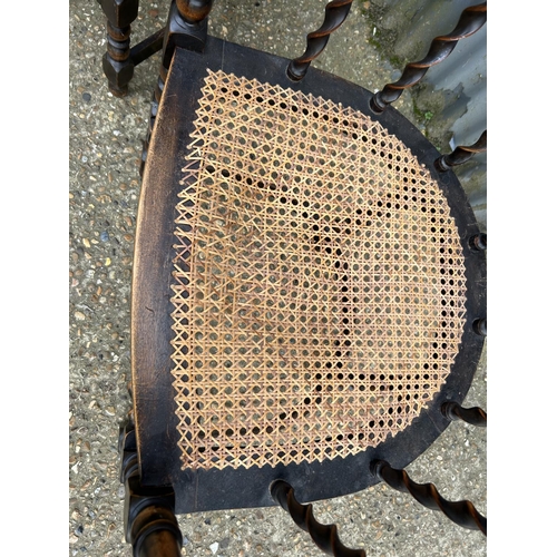 85 - A pair of oak barley twist tub chairs with bergere  seats