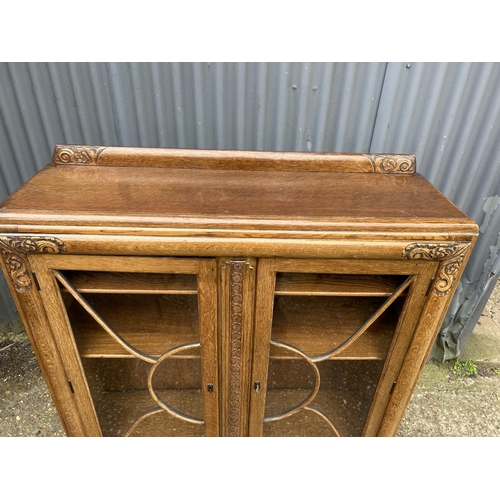 89 - A 1920's glazed oak bookcase 110x30x120