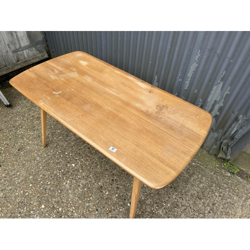 97 - An Ercol plank top dining table