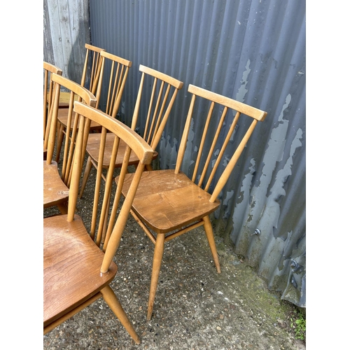 98 - A set of 9 Ercol light light elm stick back chairs (one AF to back spindle)