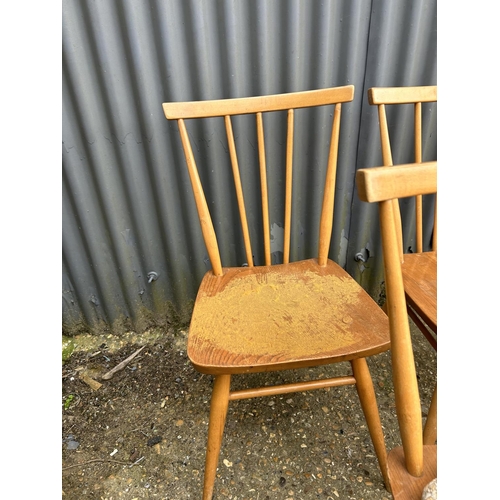 98 - A set of 9 Ercol light light elm stick back chairs (one AF to back spindle)