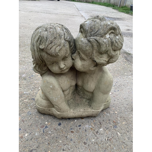 509 - A weathered Stone Figure and of children, height 45cms, width 40cms