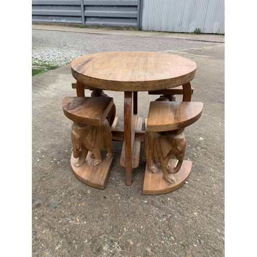 558 - Carved hardwood African Elephant child's table and stools, (2 elephants missing 1 tusk)