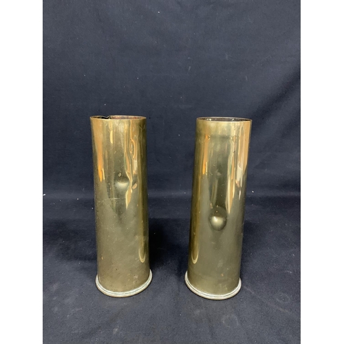 568 - 2 brass Trenchart Shell cased, height 29cms