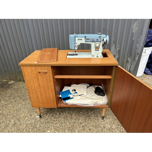 101 - A mid century teak cased sewing machine with JONES MACHINE