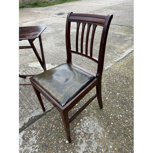 134 - A mahogany folding table together with two mahogany chairs with green leather seats