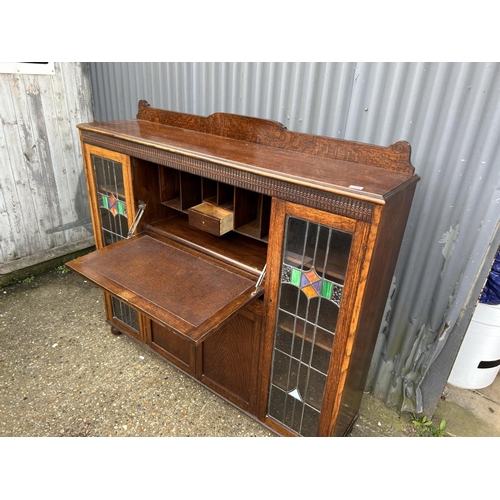 168 - A early 20th oak bureau cabinet with fall front and leaded glass doors 152x36x130