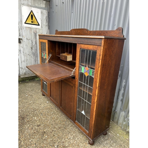 168 - A early 20th oak bureau cabinet with fall front and leaded glass doors 152x36x130